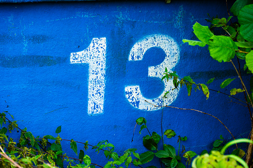 The number 13 painted on a blue glass fibre tub.