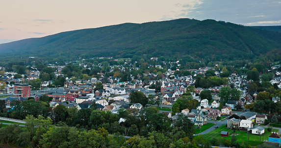 Aerial establishing shot of Williamsport in Lycoming County, Pennsylvania on a Fall evening. Authorization was obtained from the FAA for this operation in restricted airspace.