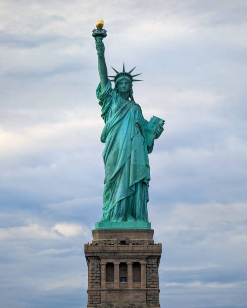 istock The Statue of Liberty stands against a cloudy sky. 1895473947