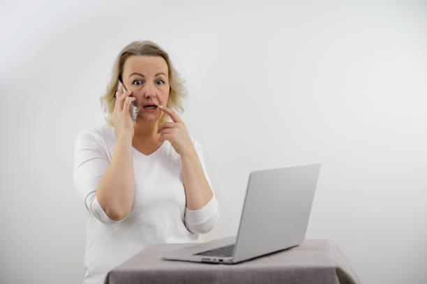 istock Woman gossip when she look at laptop 1895570857