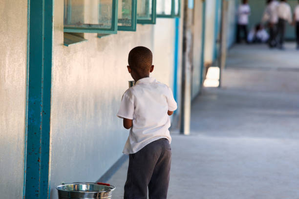 african kid at school drinking water