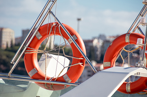 orange life preservers on the boat at the pier