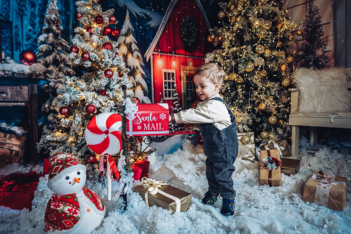 Smiling Toddler Sending Mail To Santa Claus For Christmas