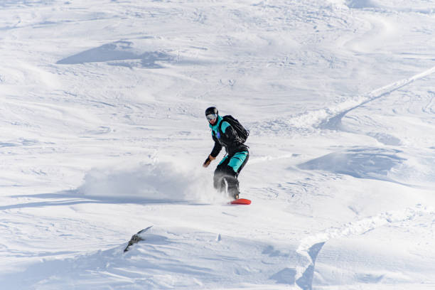 istock Freerider on snowboard masterfully ride down off-piste in deep fresh snow in Gudauri Georgia 1895676677