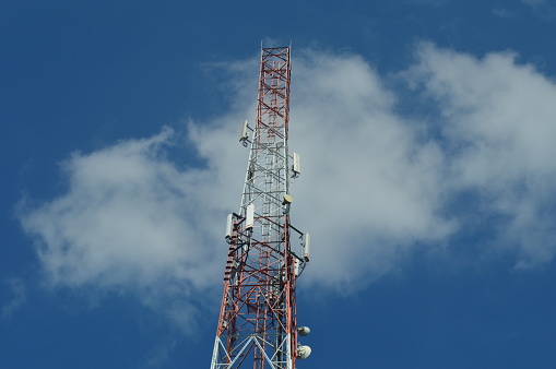 selective focus, Base Transceiver Station ( BTS ) tower against blue sky background at daytime.