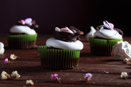 Festive baked goods with exuberant spring colors on a dark woody background.
