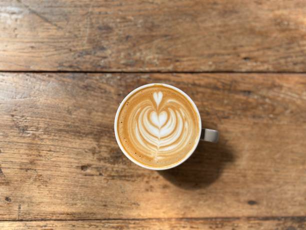 istock Cup of coffee on wooden table , Top view 1895693560