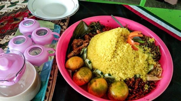 istock Tumpeng yellow rice that has collapsed from being eaten 1895704425