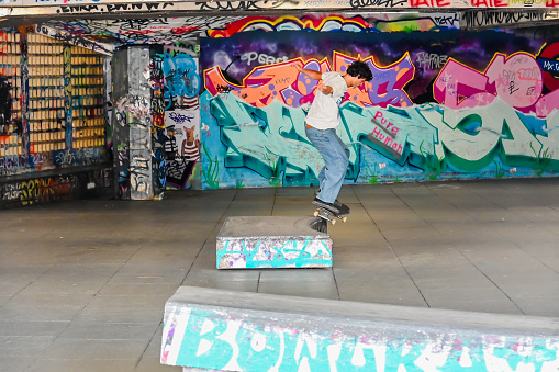 London, UK, 15 August 2023: Young British skateboarder skating at London Southbank Skate Space, an urban culture landmark used by skateboarders