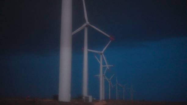 istock Thunderstorm over wind farm. Renewable energy concept. copy space 1895816879