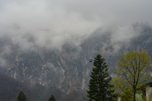 two cabs ropeway in heavy fog, mountain forest