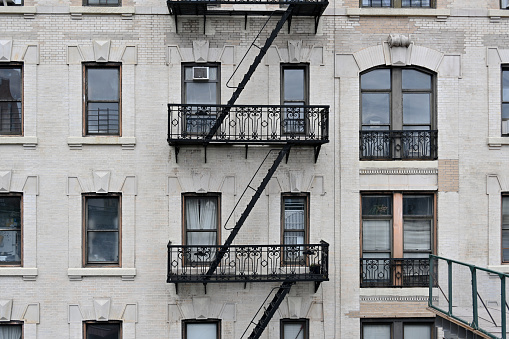 New York City, New York, USA, April 7, 2023 - Close-up of a New York City style apartment building with emergency staircase in Morningside Heights, New York, USA, New York City, USA.