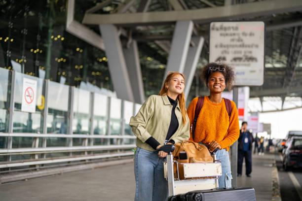 istock Woman hail a cab at airport terminal. 1895939126