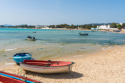 Traditional fishing boat on the sandy bech in Hammamet, Tunisia.