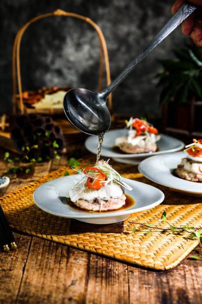 Various snacks and Chinese food in high end sophisticated fine dining restaurant, expensive food, dark background with smoke