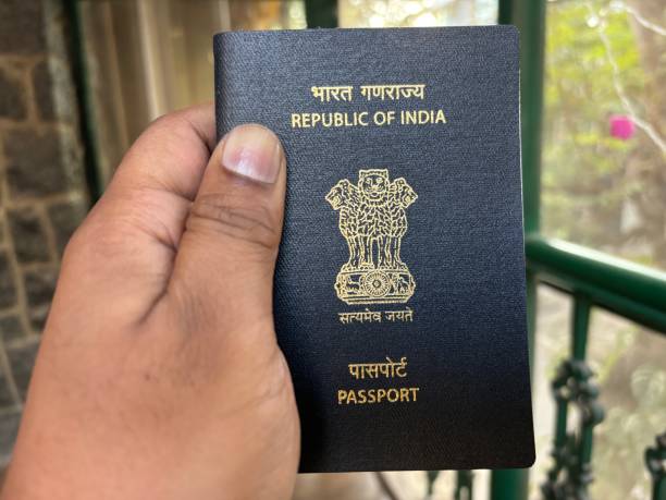 istock Fingers holding Indian Passport 1896051408