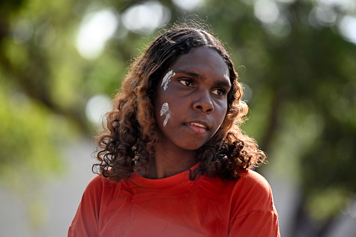 Laura, Qld - July 08 2023:Indigenous Australians woman during ceremonial dance in Laura Quinkan Dance Festival Cape York Queensland Australia.Ceremonies combine dance,body decorations and costumes.