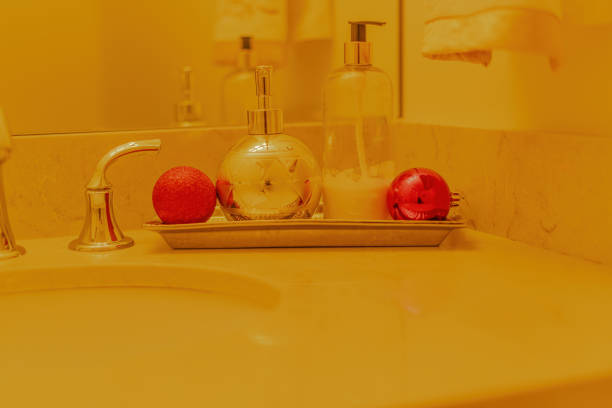 Christmas ornaments adorn the counter top in the powder room,