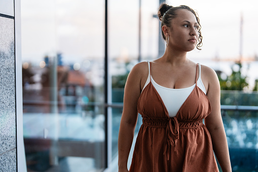 Confident Pacific Islander woman in casual clothing looking away.