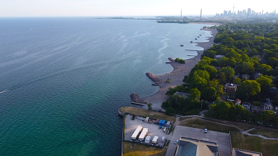 An aerial view of Lake Ontario and the beaches with Ashbridges Bay and downtown Toronto visible.
