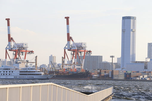 Tokyo - May 3 2023: giant container ship pass through the channel of tokyo bay near Odaiba. Exports from Japan unexpectedly edged up 0.6% yoy to JPY 7,292.6 billion in May 2023