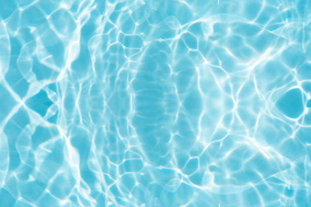 istock Bluewater waves on the surface ripples blurred. Defocus blurred transparent blue colored clear calm water surface texture with splash and bubbles. Water waves with shining pattern texture background. 1896263468