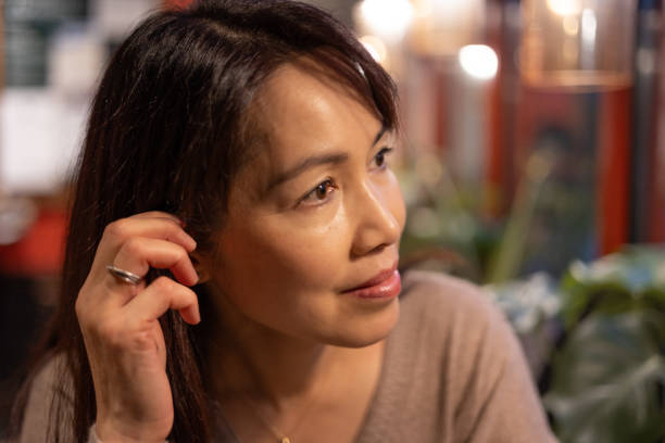 istock Asian Woman Sitting in a Cafe 1896284983