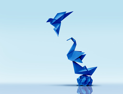 Aspiring for Greatness and Pursuing Excellence or climbing higher concept and advancing to new heights metaphor as blue origami paper sculptures as symbols of personal development or business training.