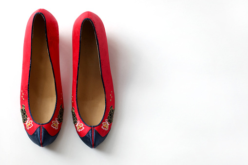 A pair of red and dark navy blue traditional Korean Gomusin shoes. Women's gomusin are called danghye.