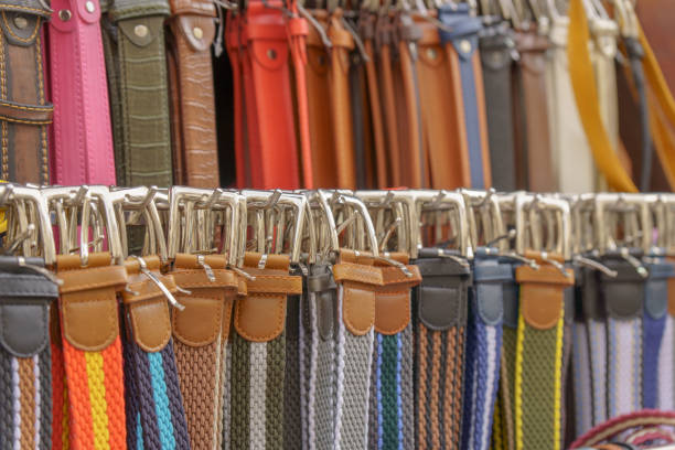 Closeup of many belts leather colorful vibrant colors pattern hanging on display in shopping street market