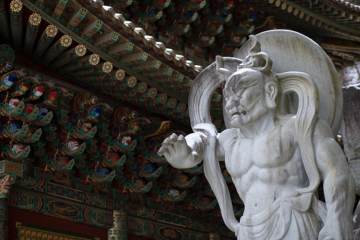 Stone demon guard statuesque, guardian statue at the entrance to the Korean Buddhist Temple Guinsa. Danyang Region, South Korea, Asia.