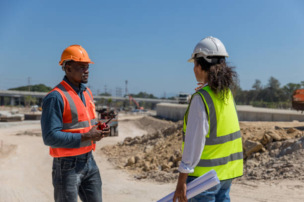 istock Civil engineers and architects wearing safety gear inspect the construction site . Engineer inspecting and working outdoors structure building site. Engineering and architecture concept. 1896590568