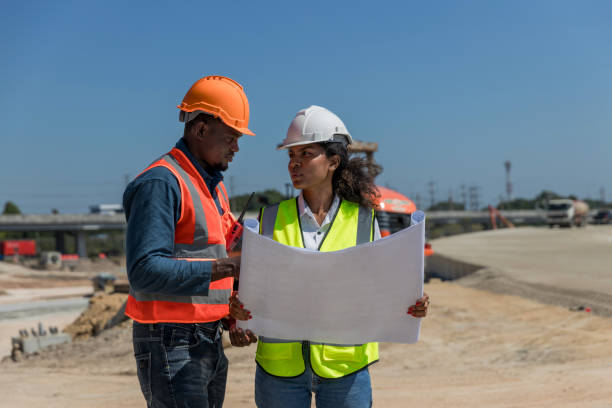 istock Civil engineers and architects wearing safety gear inspect the construction site . Engineer inspecting and working outdoors structure building site. Engineering and architecture concept. 1896590569