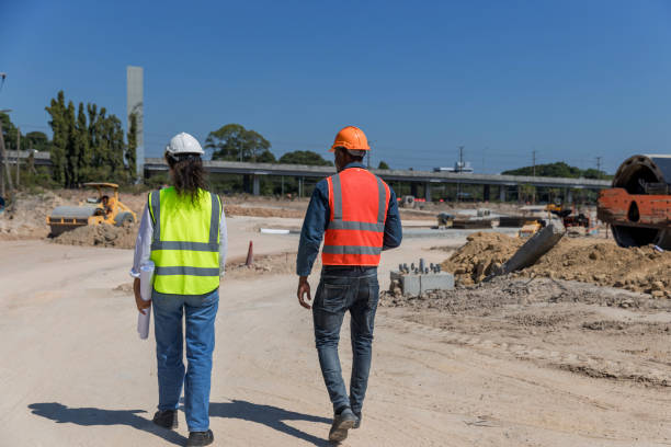 istock Civil engineers and architects wearing safety gear inspect the construction site . Engineer inspecting and working outdoors structure building site. Engineering and architecture concept. 1896590572