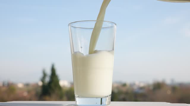 Pouring organic fresh milk to the glass