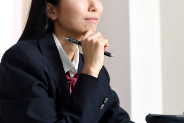 istock Asian female student thinking at home 1896644133