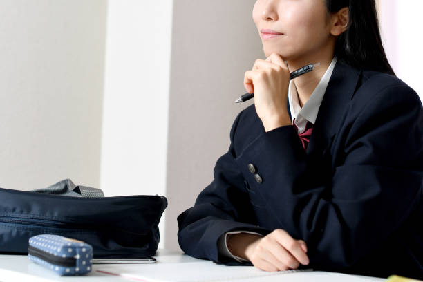 istock Asian female student thinking at home 1896644135