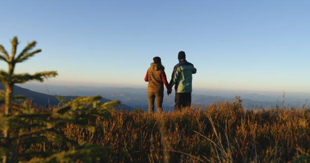 istock Tourist couple walk beautiful mountain valley 1896645670