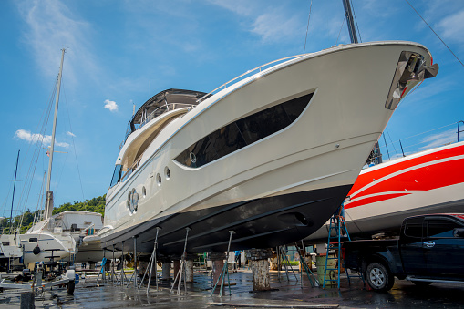 Motor yacht moored for repairs and service in dry dock.