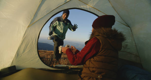 istock Tourist pours water from boiling kettle in cups 1896672847