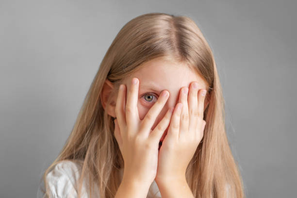 istock A little girl covering her face with her hands 1896699645
