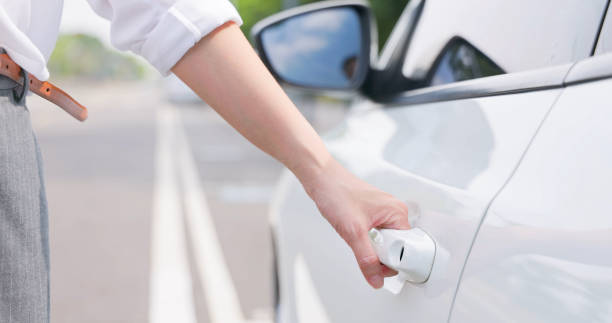 istock asian woman open car door 1896701738