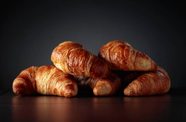 istock Freshly baked croissants on a black ceramic table. 1896720852