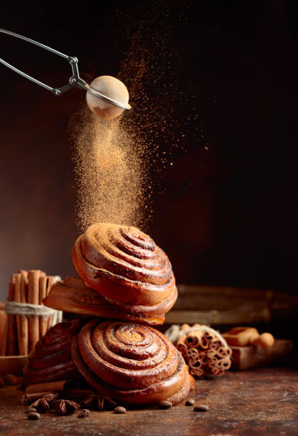 Freshly baked sweet buns sprinkled with cinnamon powder.
