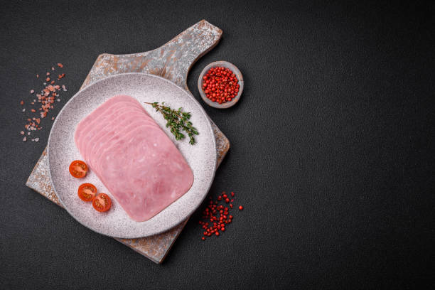 istock Delicious fresh ham cut into slices with salt, spices and herbs 1896803328