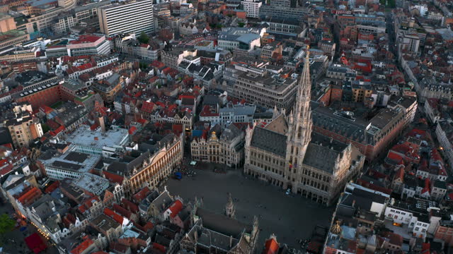 Sunset skyline of the City of Brussels, Belgium: Aerial view of Grand Place square and Town Hall (Hôtel de Ville de Bruxelles)