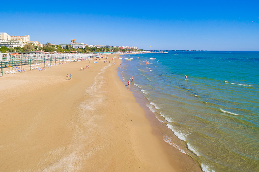 Sunny beach with golden sands blue sky and azure sea