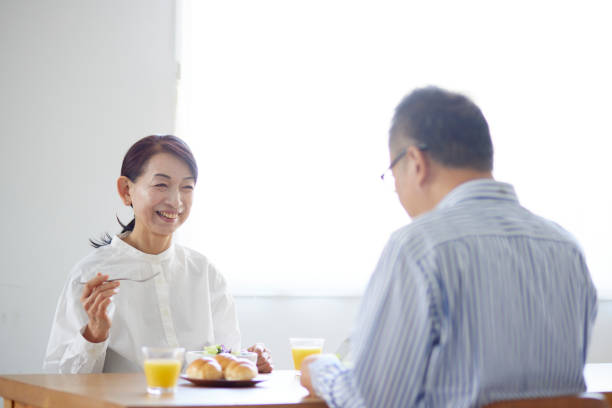 Japanese senior couple eating breakfast