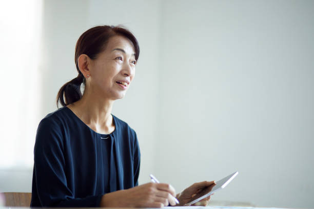 istock A senior Japanese woman using a tablet device 1896835700