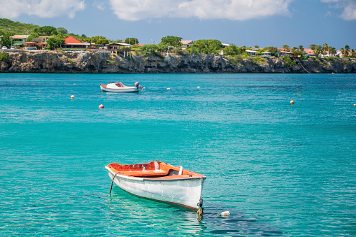 small boats, anchored in the sea, just off the coast of Playa Grandi beach, Curacao, Caribbean